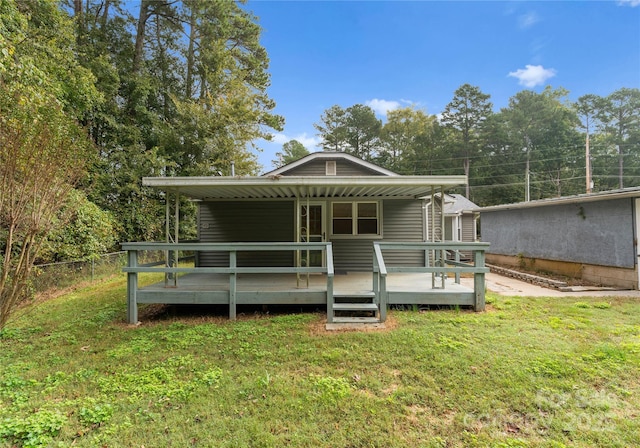 view of front facade featuring a wooden deck and a front yard