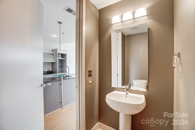 bathroom featuring hardwood / wood-style floors and toilet