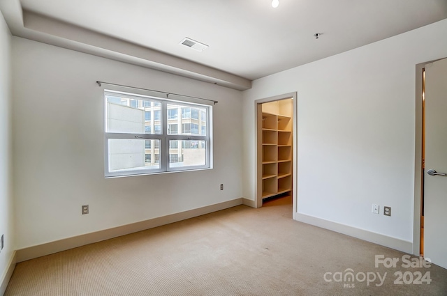 unfurnished room featuring light colored carpet