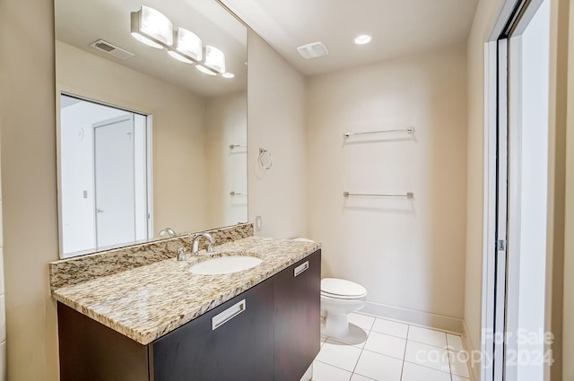 bathroom featuring vanity, tile patterned flooring, and toilet