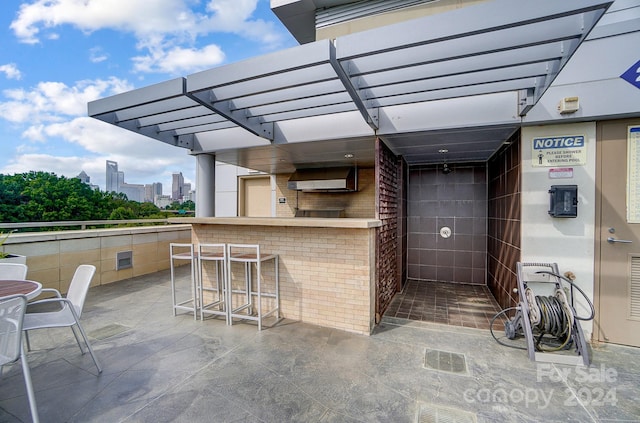 view of patio / terrace featuring a pergola and a bar