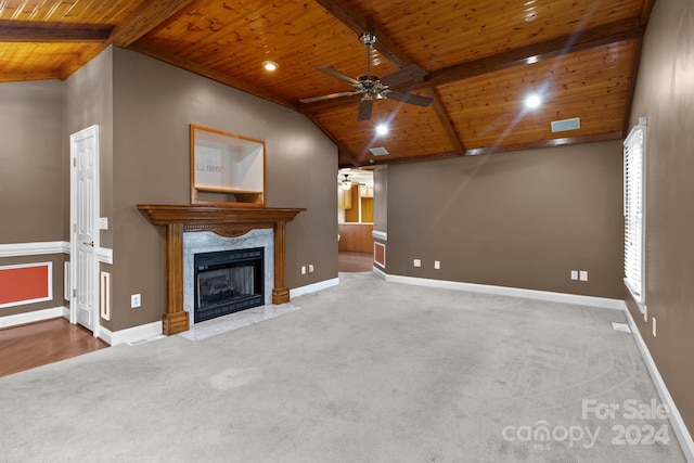 unfurnished living room with lofted ceiling with beams, ceiling fan, wooden ceiling, and a fireplace