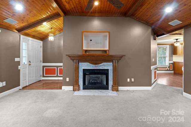 unfurnished living room featuring lofted ceiling with beams, a fireplace, wooden ceiling, ceiling fan, and hardwood / wood-style flooring