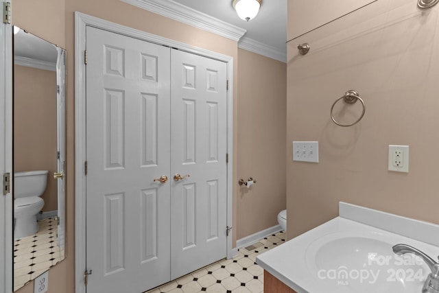 bathroom with crown molding, vanity, and toilet