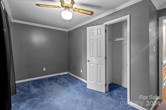 unfurnished bedroom featuring ornamental molding, ceiling fan, a closet, and dark carpet