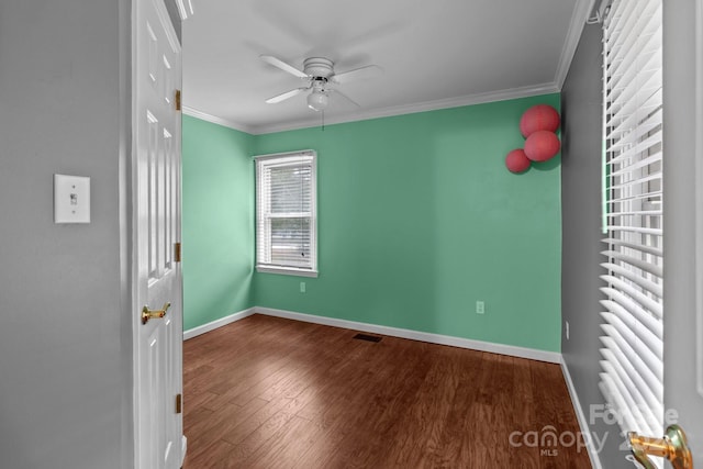 empty room with wood-type flooring, ornamental molding, and ceiling fan