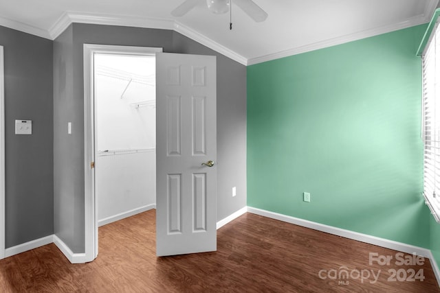 unfurnished bedroom featuring a closet, ceiling fan, hardwood / wood-style flooring, and crown molding