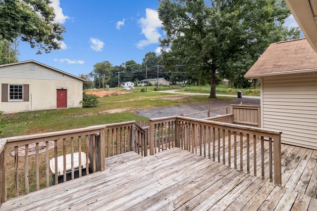 wooden deck featuring a yard