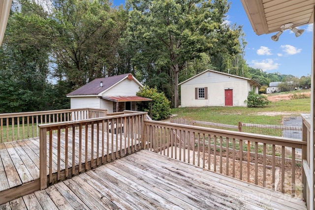 deck with a lawn and an outbuilding