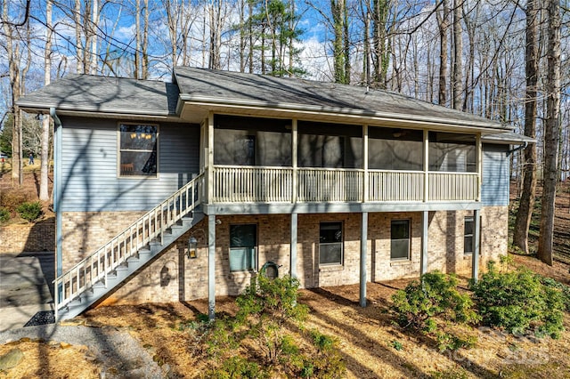 back of house featuring a sunroom