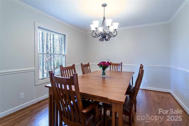 dining area with crown molding, dark wood-type flooring, and an inviting chandelier