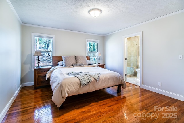 bedroom with dark hardwood / wood-style flooring, connected bathroom, crown molding, and a textured ceiling