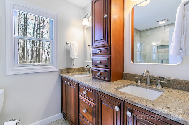 bathroom with tile patterned flooring, vanity, and walk in shower