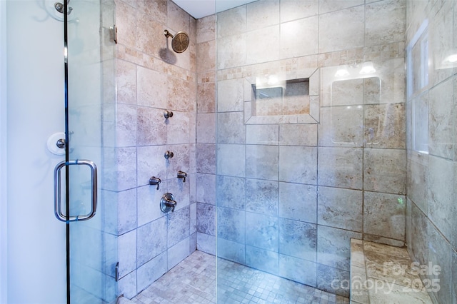 bathroom with a shower with shower door