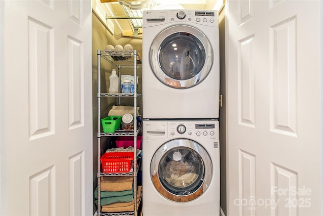 washroom featuring stacked washer and clothes dryer