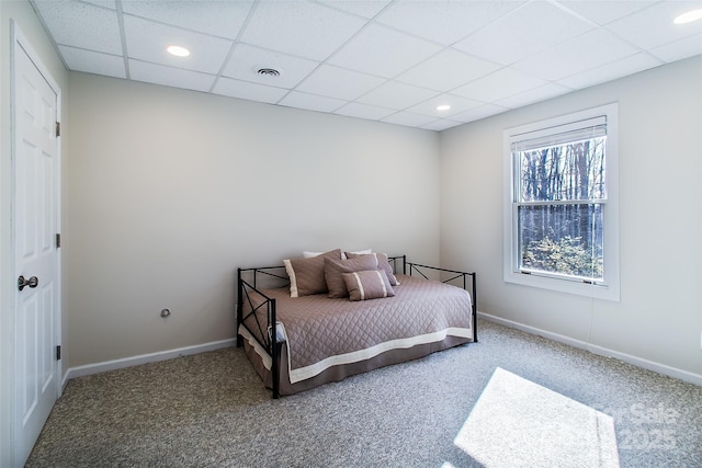 bedroom featuring carpet floors and a paneled ceiling