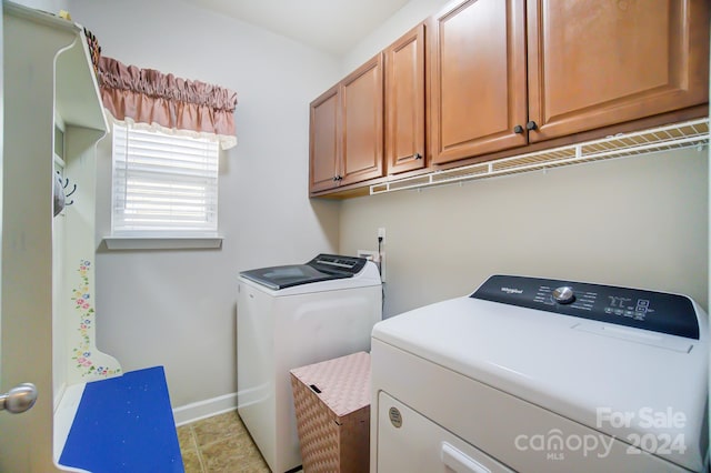 laundry area with washer and dryer and cabinets