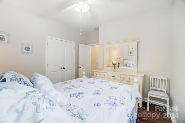 bedroom with a ceiling fan, a closet, and dark wood-style flooring