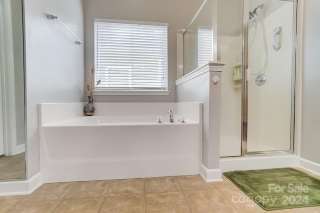 bathroom with tile patterned flooring and independent shower and bath