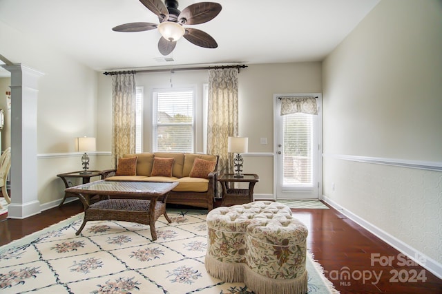 living area with plenty of natural light, wood finished floors, and ceiling fan