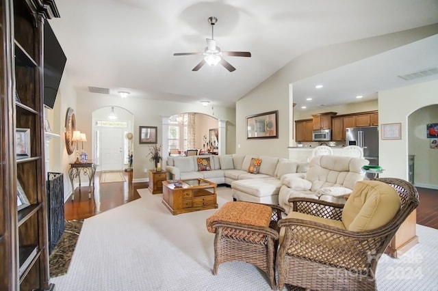 living room featuring vaulted ceiling, dark hardwood / wood-style flooring, and ceiling fan