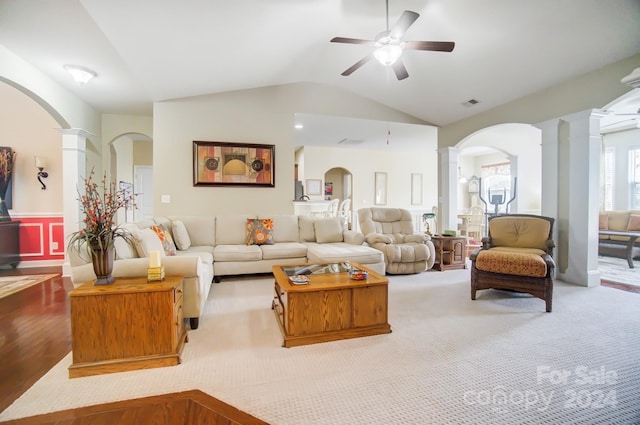 living area featuring arched walkways, ceiling fan, vaulted ceiling, and ornate columns