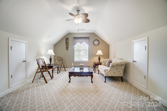 sitting room featuring ceiling fan, light colored carpet, and lofted ceiling