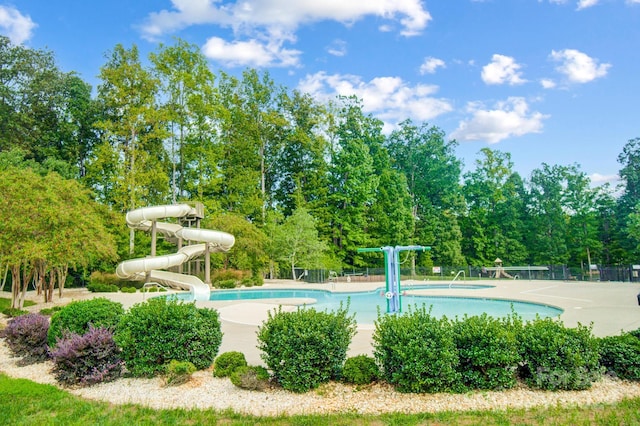 pool featuring fence and a water slide