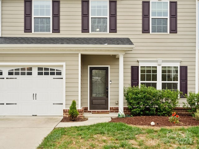 view of exterior entry with a garage