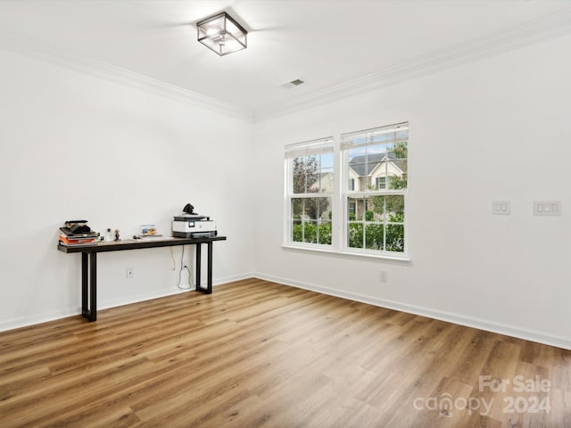 unfurnished room featuring crown molding and hardwood / wood-style flooring