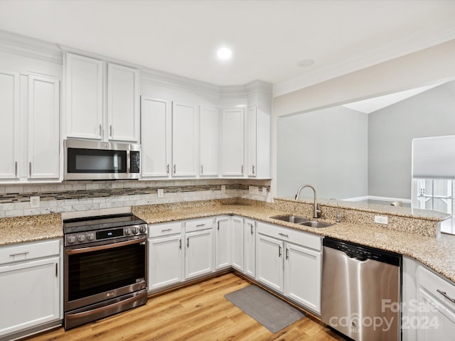 kitchen with stainless steel appliances, sink, and white cabinetry