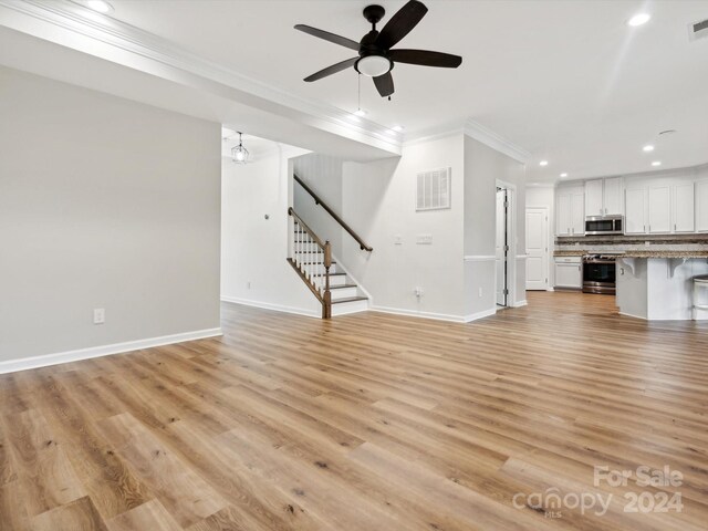 unfurnished living room with light hardwood / wood-style floors, ceiling fan, and crown molding