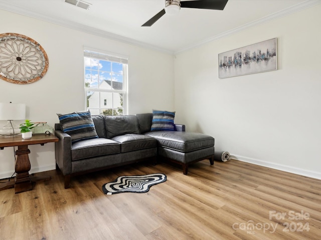 living room featuring crown molding, ceiling fan, and hardwood / wood-style flooring