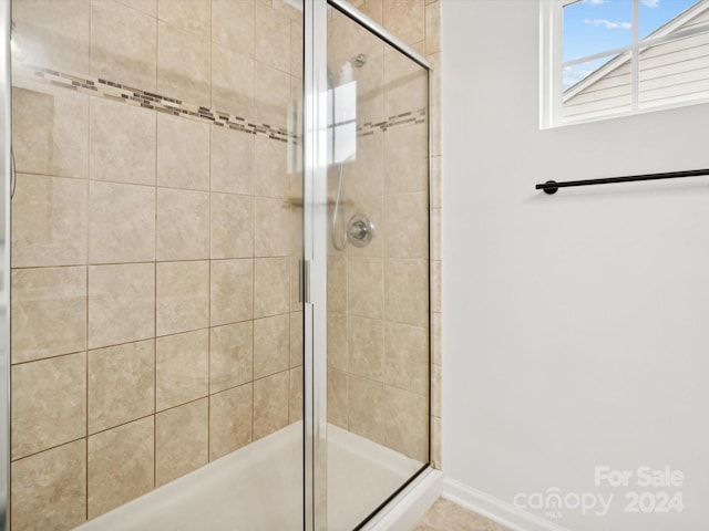 bathroom featuring a shower with shower door