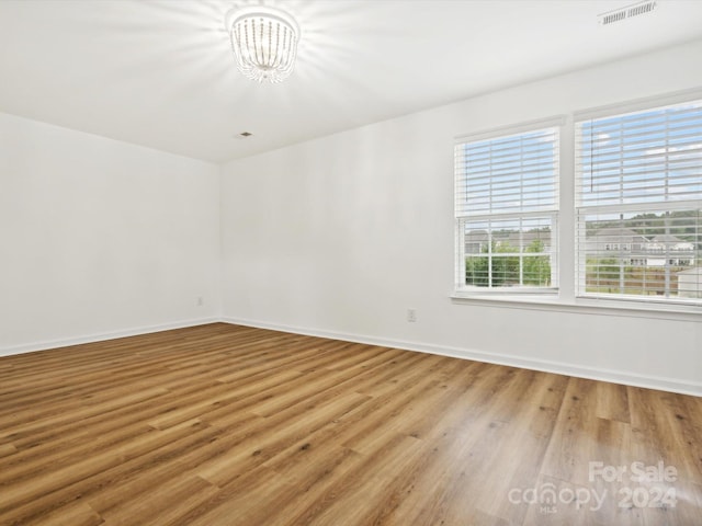 unfurnished room with wood-type flooring