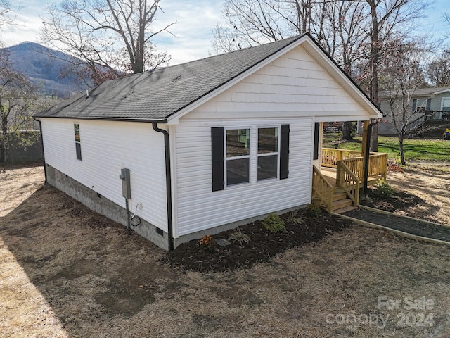 view of home's exterior with a deck with mountain view