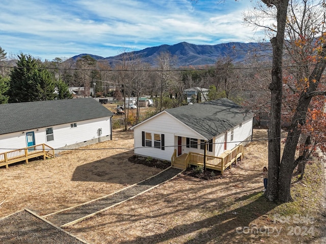 exterior space with a deck with mountain view