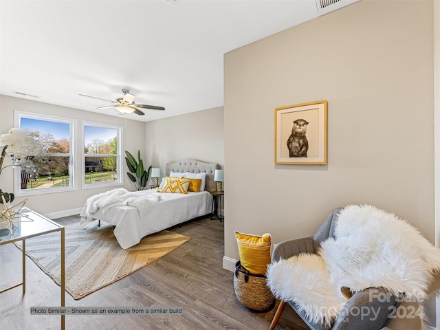 bedroom with ceiling fan and dark hardwood / wood-style flooring