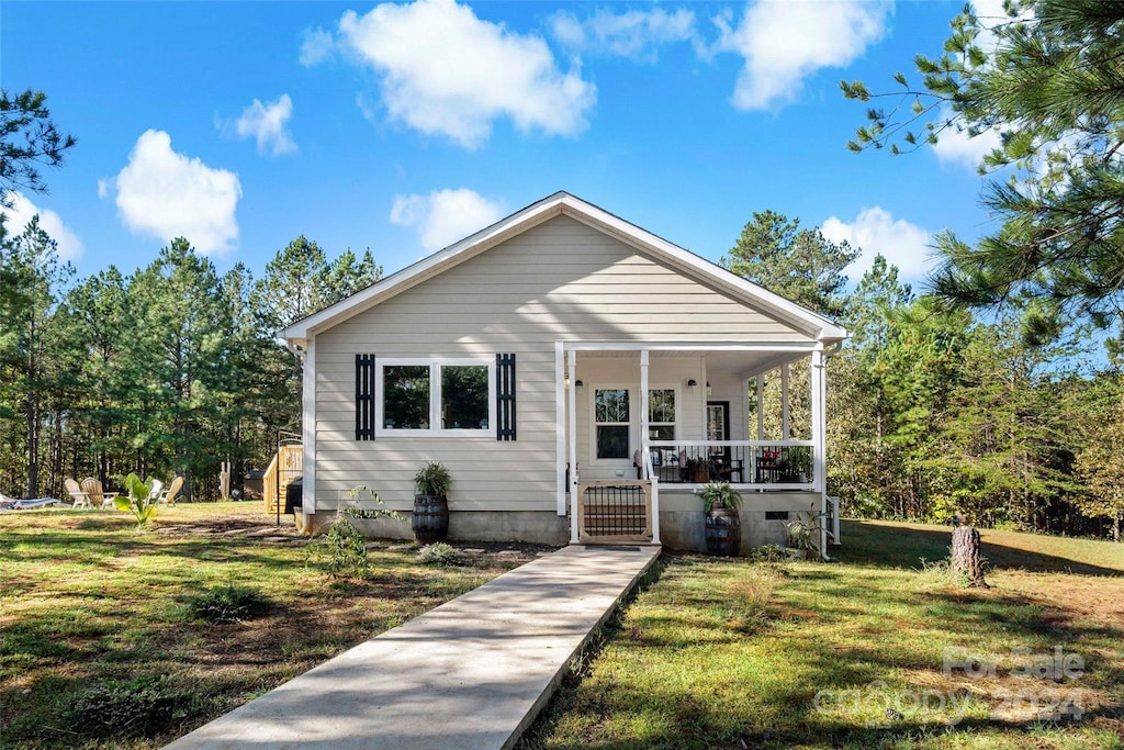 bungalow-style home with a front yard and a porch