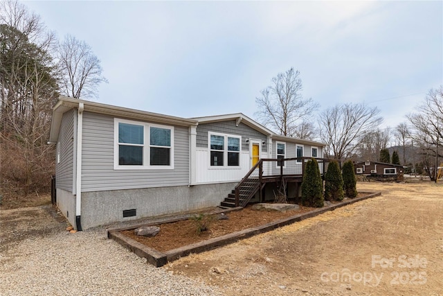 manufactured / mobile home featuring a wooden deck