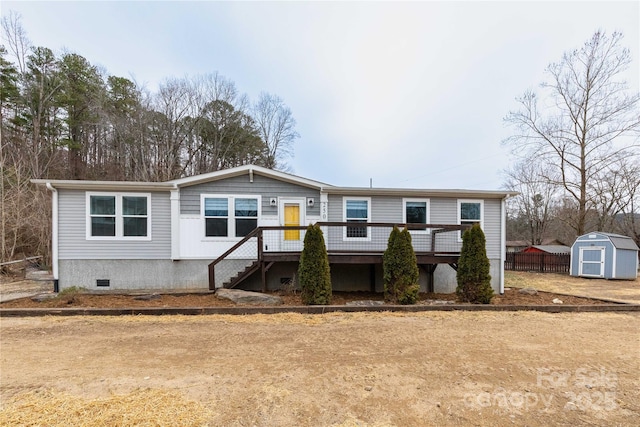 manufactured / mobile home with a wooden deck and a shed