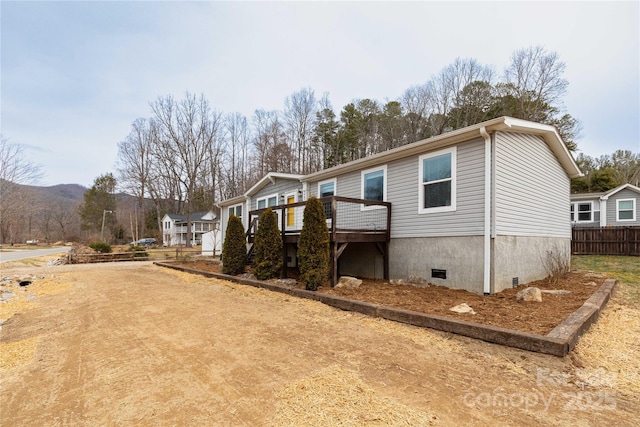 view of front of property with a wooden deck