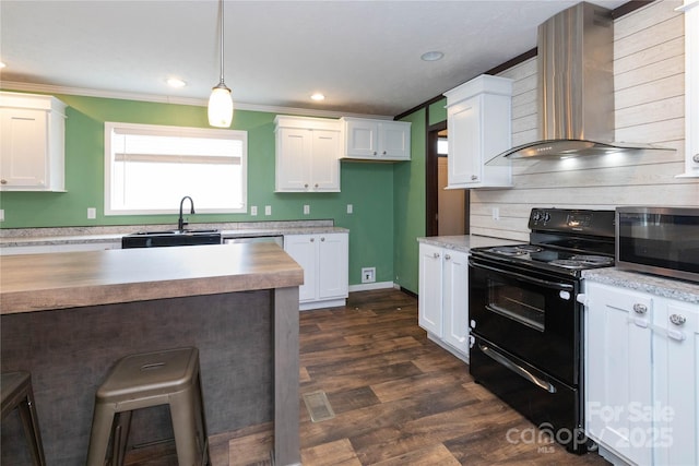 kitchen featuring sink, white cabinetry, hanging light fixtures, black range with electric cooktop, and wall chimney exhaust hood