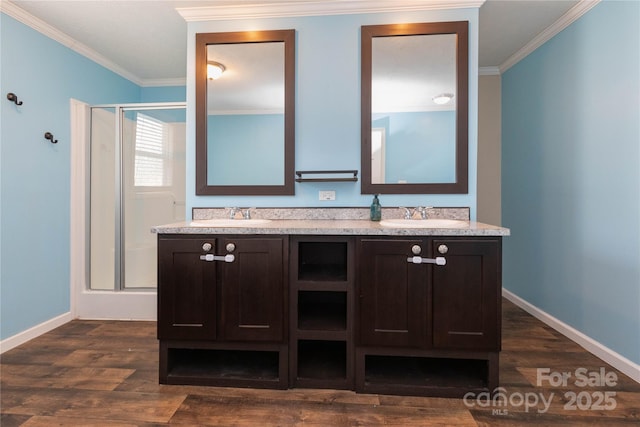 bathroom featuring vanity, hardwood / wood-style flooring, and ornamental molding