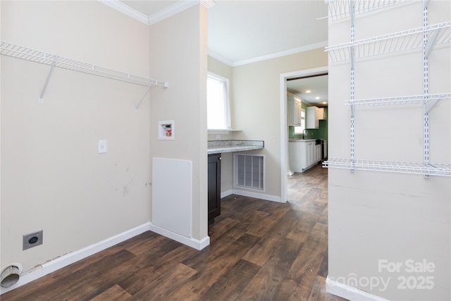 laundry room with sink, dark hardwood / wood-style flooring, ornamental molding, washer hookup, and hookup for an electric dryer