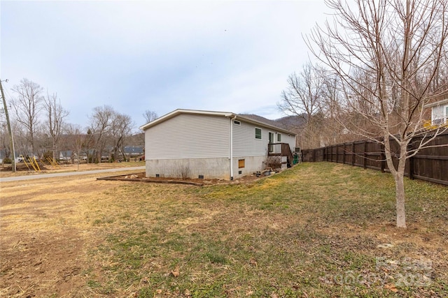 view of side of property with a lawn