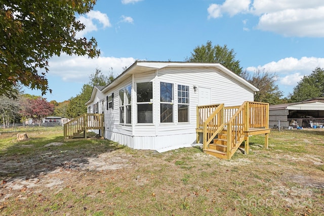 rear view of house featuring a yard and a gazebo