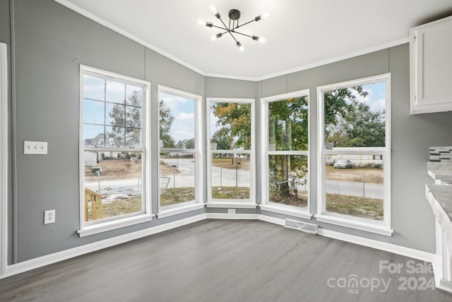 unfurnished sunroom with a wealth of natural light and a notable chandelier