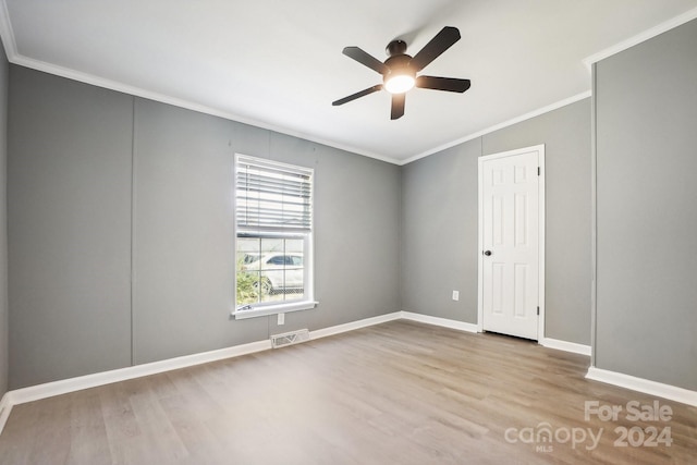 spare room with ornamental molding, ceiling fan, and light hardwood / wood-style flooring