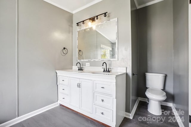 bathroom with hardwood / wood-style flooring, vanity, toilet, and ornamental molding